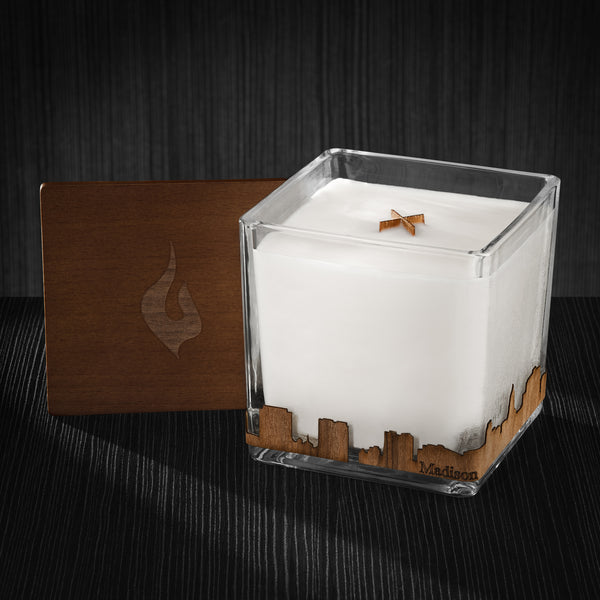 Image of a 4x4x4 soy candle featuring a mahogany scent, crackling wood wick, with a wood lid and a Madison City skyline wrap design.