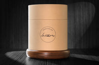 12oz revolving glass with a reversible wood coaster inside of quality made storage container. 