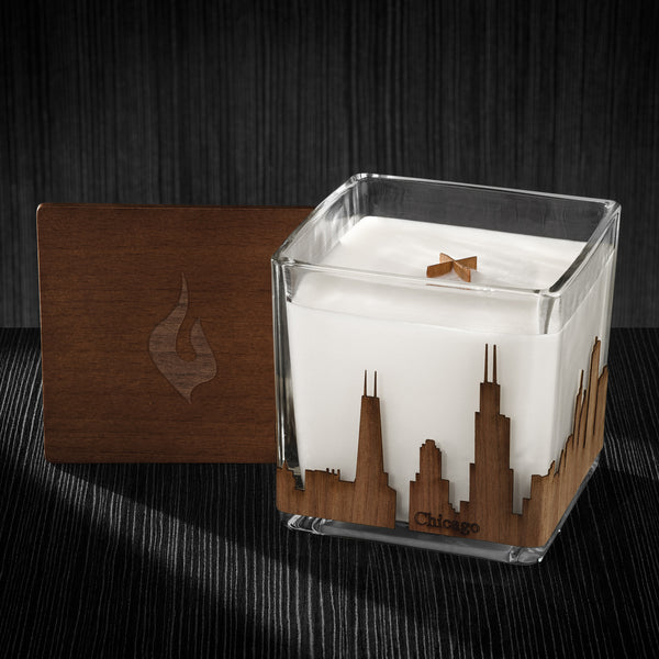 Image of a 4x4x4 soy candle featuring a mahogany scent, crackling wood wick, with a wood lid and an Chicago, IL skyline wrap design.