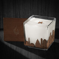 Image of a 4x4x4 soy candle featuring a mahogany scent, crackling wood wick, with a wood lid and a Milwaukee City skyline wrap design.