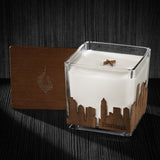 Image of a 4x4x4 soy candle featuring a mahogany scent, crackling wood wick, with a wood lid and a Pittsburgh skyline wrap design.