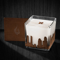 Image of a 4x4x4 soy candle featuring a mahogany scent, crackling wood wick, with a wood lid and a San Diego skyline wrap design.
