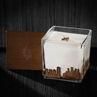 Image of a 4x4x4 soy candle featuring a mahogany scent, crackling wood wick, with a wood lid and a Seattle skyline wrap design.