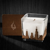 Image of a 3x3x3 soy candle featuring a mahogany scent, crackling wood wick, with a wood lid and an Chicago, IL skyline wrap design.