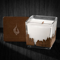 Image of a 3x3x3 soy candle featuring a mahogany scent, crackling wood wick, with a wood lid and a Detroit skyline wrap design.