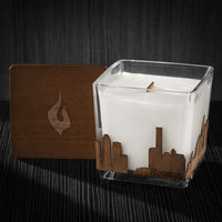 Image of a 3x3x3 soy candle featuring a mahogany scent, crackling wood wick, with a wood lid and a Houston skyline wrap design.