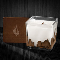 Image of a 3x3x3 soy candle featuring a mahogany scent, crackling wood wick, with a wood lid and an Indianapolis skyline wrap design.