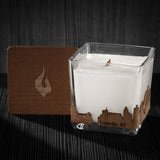 Image of a 3x3x3 soy candle featuring a mahogany scent, crackling wood wick, with a wood lid and a Louisville, KY City skyline wrap design.