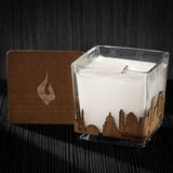 Image of a 3x3x3 soy candle featuring a mahogany scent, crackling wood wick, with a wood lid and a Milwaukee City skyline wrap design.
