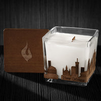 Image if a 3x3x3 soy candle featuring a mahogany scent, crackling wood wick, with a wood lid and a New Orleans skyline wrap design.