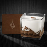 Image of a 3x3x3 soy candle featuring a mahogany scent, crackling wood wick, with a wood lid and a Pacific Northwest skyline wrap design.