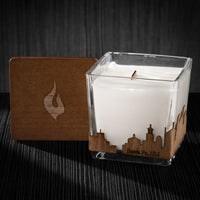 Image of a 3x3x3 soy candle featuring a mahogany scent, crackling wood wick, with a wood lid and a Santa Fe, NM skyline wrap design.