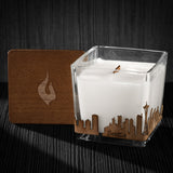 Image of a 3x3x3 soy candle featuring a mahogany scent, crackling wood wick, with a wood lid and a Seattle skyline wrap design.