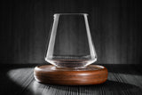 12oz revolving glass with a reversible wood coaster, standing in an idle position.