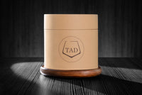 5oz revolving glass with a reversible wood coaster. Inside of its high quality packaging.